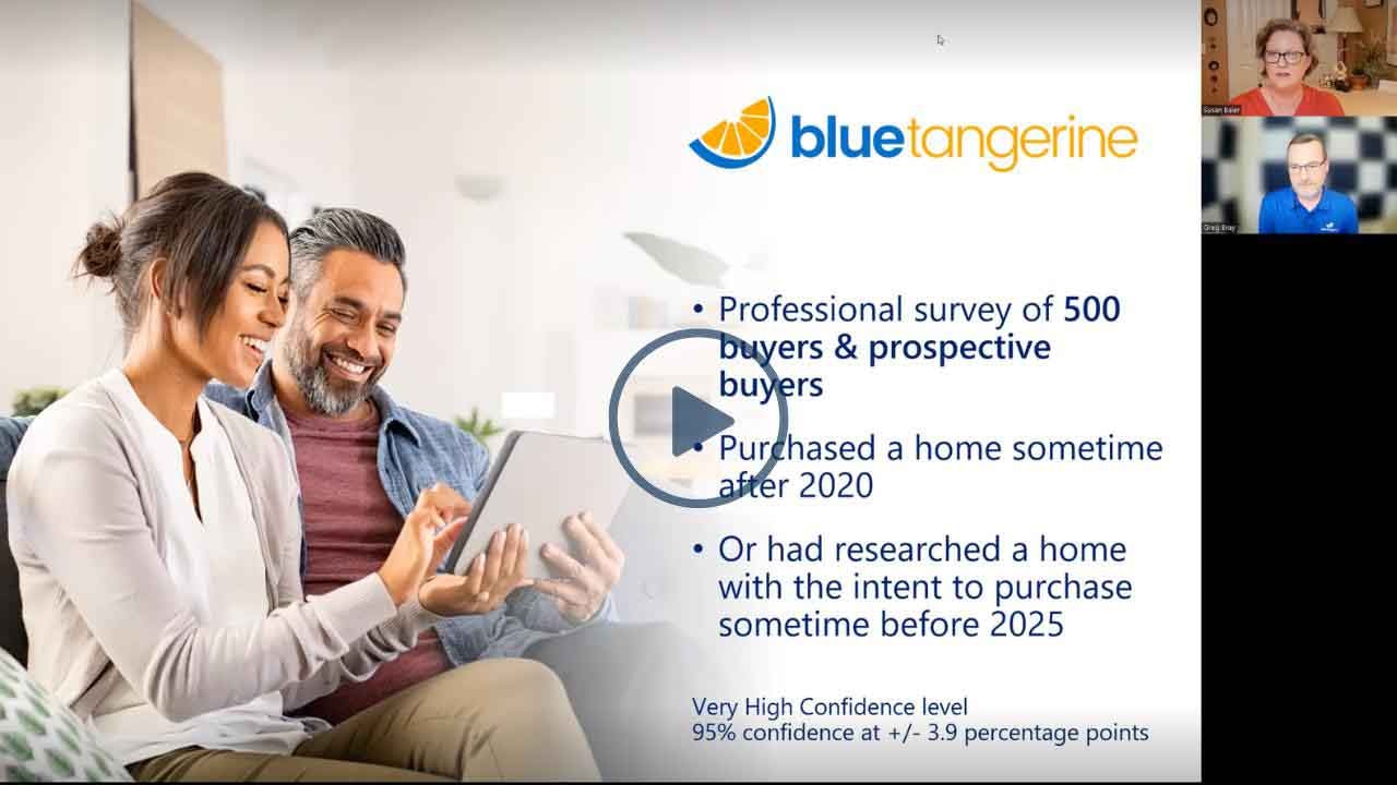 A man and a woman sitting down looking at an ipad together