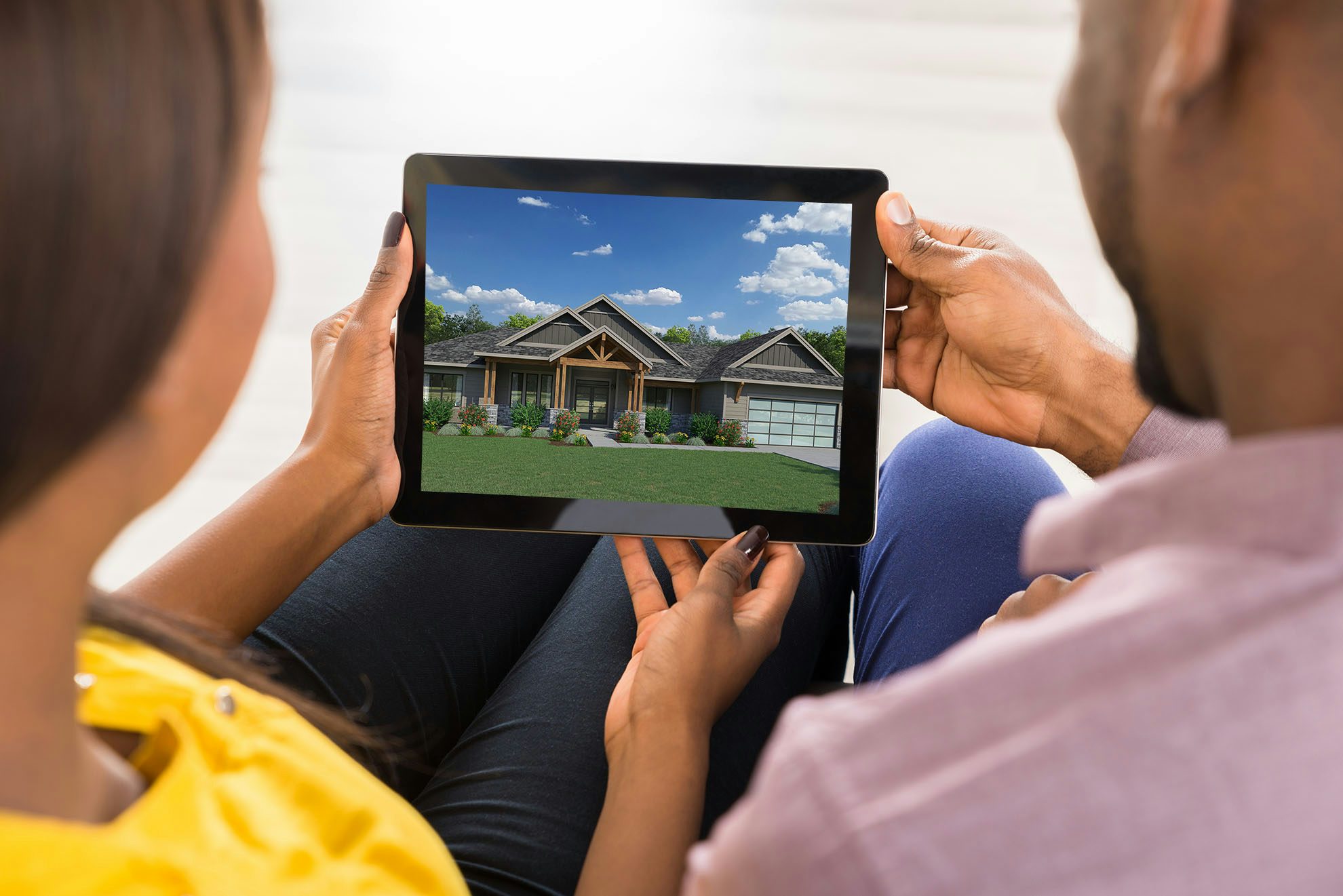 Couple looking for homes on tablet device